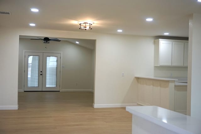 kitchen featuring ceiling fan, white cabinetry, light hardwood / wood-style flooring, and french doors