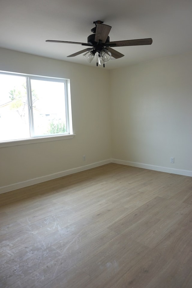 spare room featuring ceiling fan and light hardwood / wood-style floors