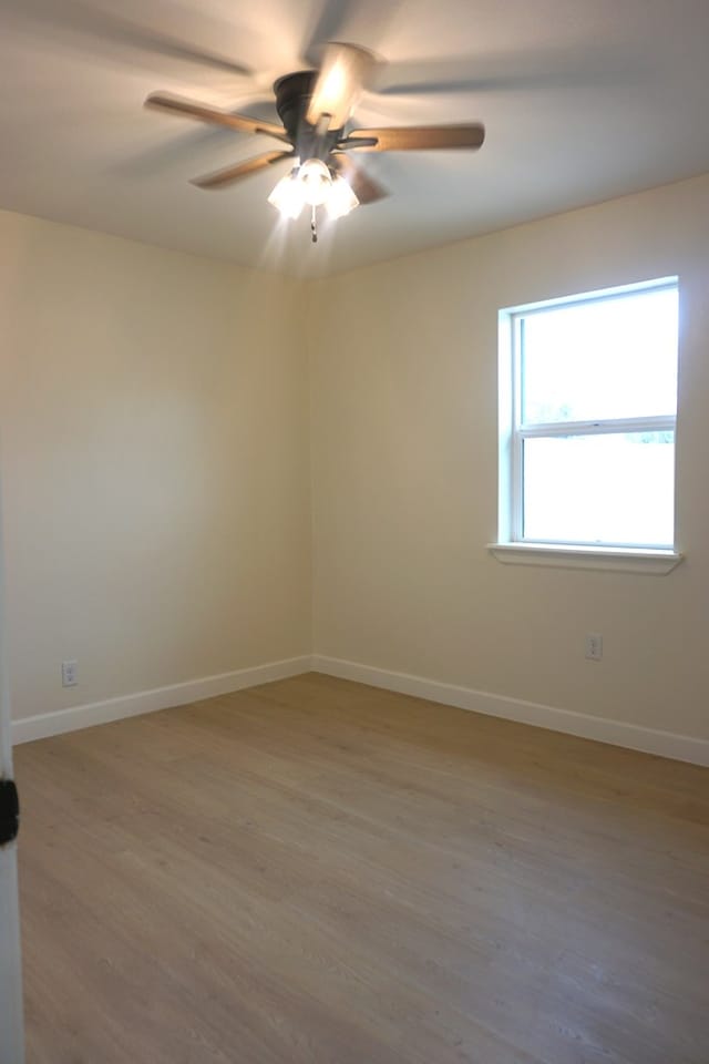 unfurnished room with ceiling fan and hardwood / wood-style floors