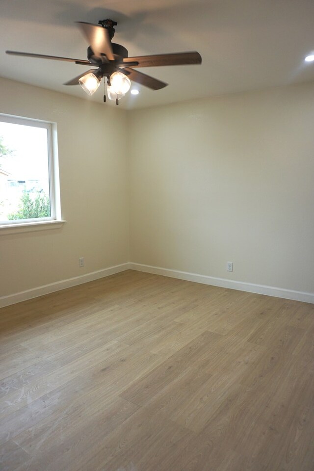 unfurnished room with ceiling fan and light hardwood / wood-style flooring