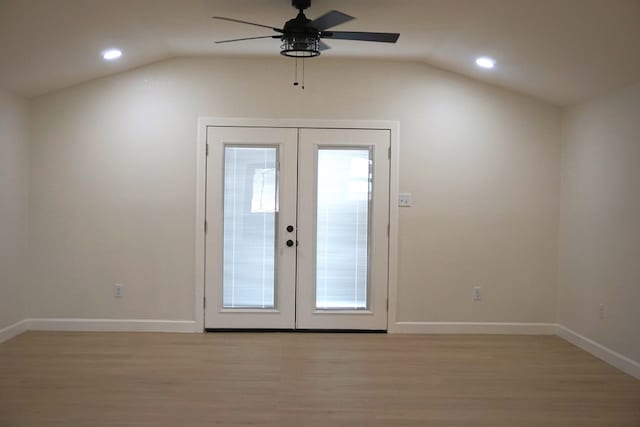 doorway featuring french doors, light wood-type flooring, and lofted ceiling