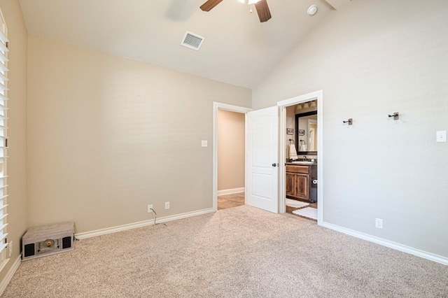 carpeted empty room featuring beamed ceiling, high vaulted ceiling, and ceiling fan