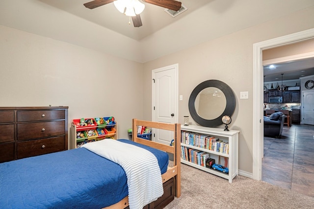 carpeted bedroom with vaulted ceiling and ceiling fan