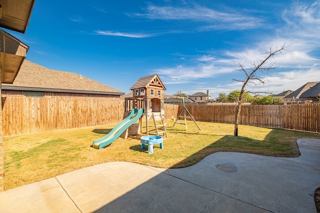 view of jungle gym featuring a lawn and a patio