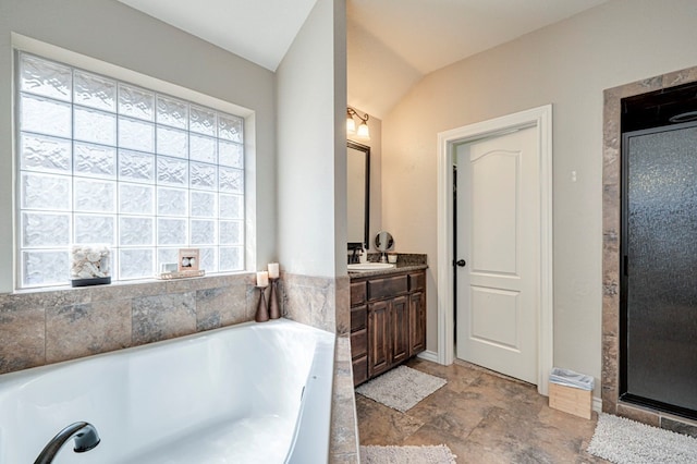 bathroom with vanity, independent shower and bath, and lofted ceiling