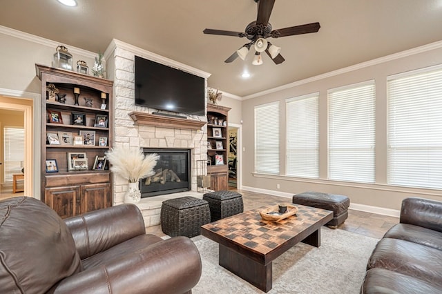 living room featuring ceiling fan, crown molding, a fireplace, and a wealth of natural light