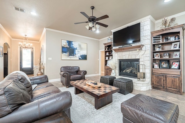 living room featuring a textured ceiling, crown molding, a fireplace, and ceiling fan with notable chandelier