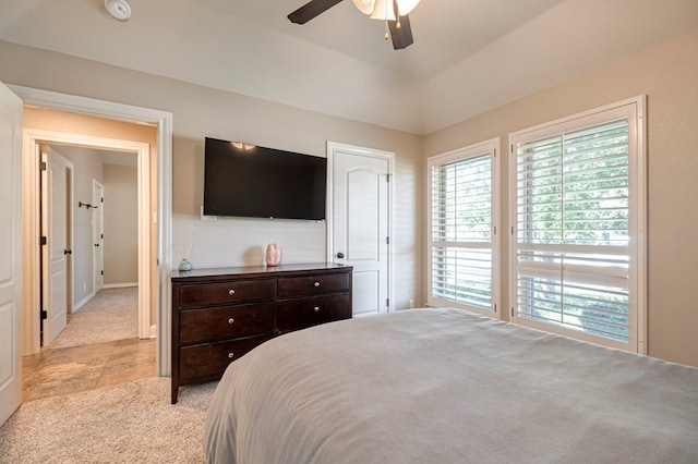 bedroom featuring ceiling fan and a raised ceiling