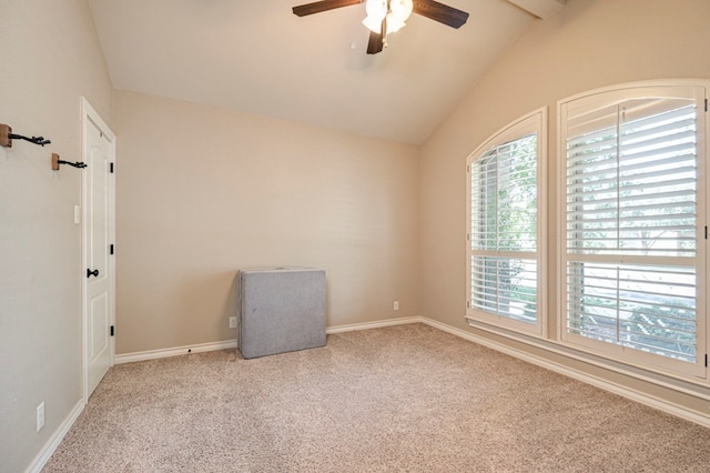 carpeted empty room featuring vaulted ceiling with beams and ceiling fan