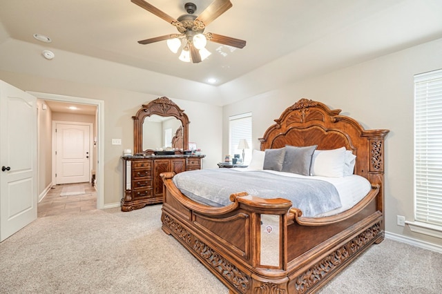 bedroom featuring light carpet and ceiling fan