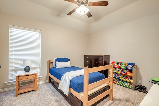 carpeted bedroom with ceiling fan and vaulted ceiling