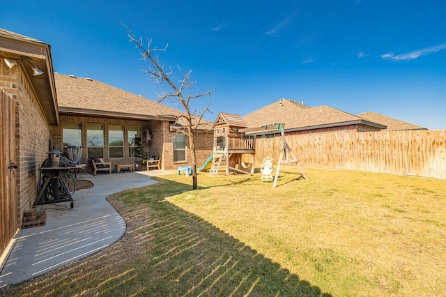 view of yard featuring a patio and a playground