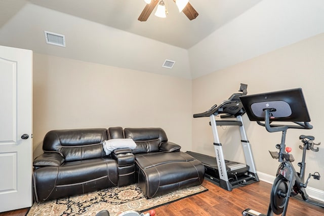 exercise room with hardwood / wood-style floors, vaulted ceiling, and ceiling fan