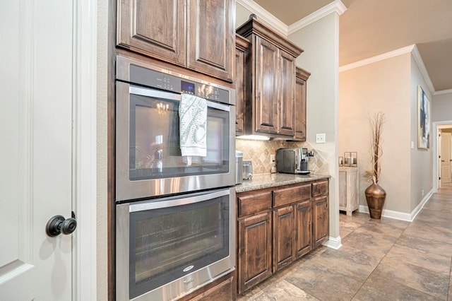 kitchen featuring tasteful backsplash, light stone counters, double oven, and ornamental molding