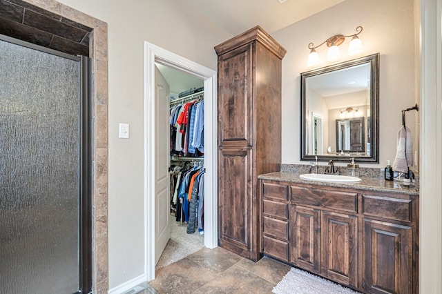 bathroom featuring vanity and a shower with door