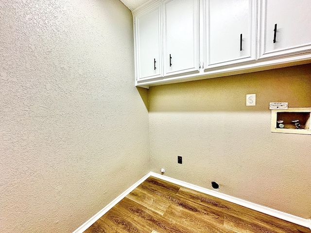 laundry area featuring cabinets, washer hookup, and wood-type flooring