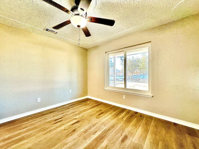 unfurnished room with wood-type flooring and ceiling fan