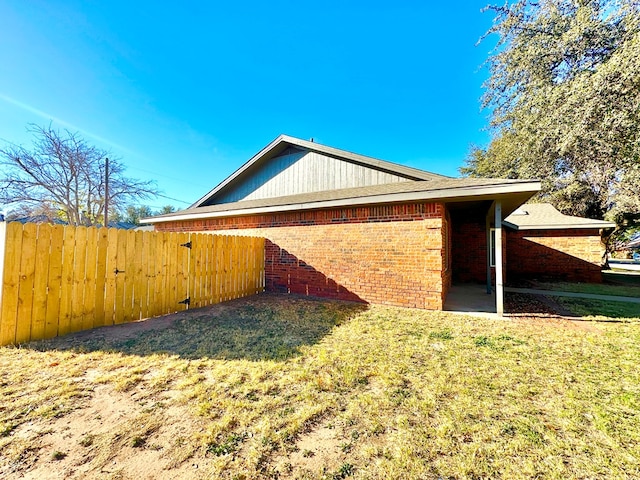 view of side of property with a lawn