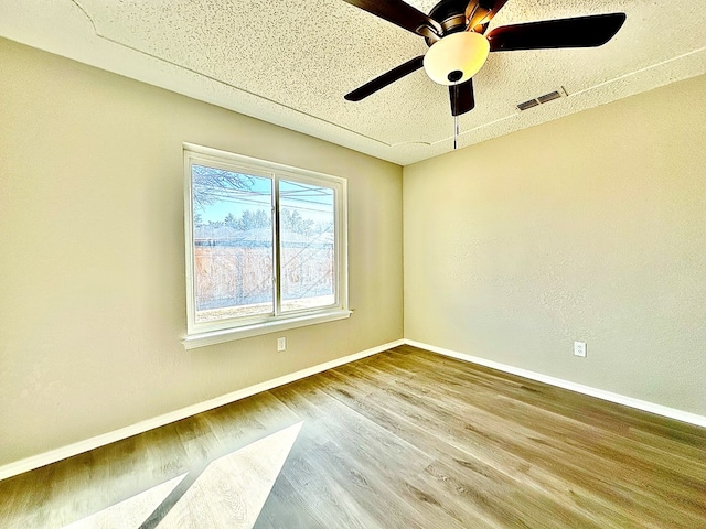 empty room with ceiling fan and wood-type flooring