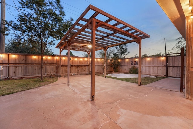 patio terrace at dusk featuring a pergola