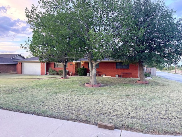 717 Tulane St, Big Spring, TX 79720 - single story home featuring brick siding, a front yard, and an attached garage