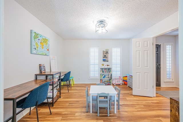 5004 Los Alamitos Dr, Midland, TX 79705 - office area featuring a textured ceiling and light wood-style floors