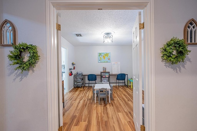 5004 Los Alamitos Dr, Midland, TX 79705 - dining space with light wood finished floors and a textured ceiling
