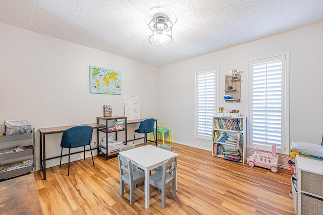 5004 Los Alamitos Dr, Midland, TX 79705 - office area with light wood-style flooring, a textured ceiling, and baseboards