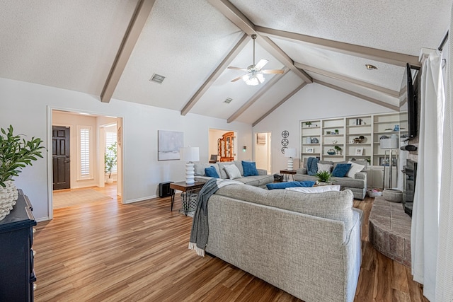 5004 Los Alamitos Dr, Midland, TX 79705 - living room featuring light wood-style floors, ceiling fan, baseboards, and a textured ceiling