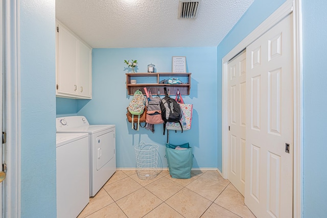 5004 Los Alamitos Dr, Midland, TX 79705 - laundry room with cabinet space, independent washer and dryer, a textured ceiling, light tile patterned floors, and baseboards