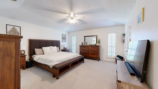 5004 Los Alamitos Dr, Midland, TX 79705 - bedroom with light carpet, a textured ceiling, and a ceiling fan