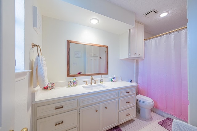 5004 Los Alamitos Dr, Midland, TX 79705 - bathroom with vanity, toilet, tile patterned floors, a shower with shower curtain, and a textured ceiling