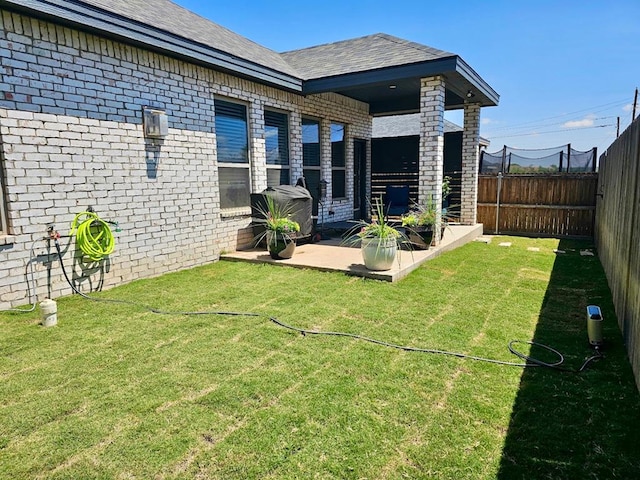 3310 Fenn St, Big Spring, TX 79720 - rear view of property with a fenced backyard, a yard, a patio area, and brick siding