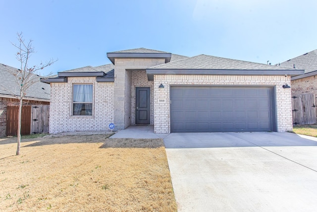 view of front of property featuring fence, concrete driveway, a front yard, a garage, and brick siding