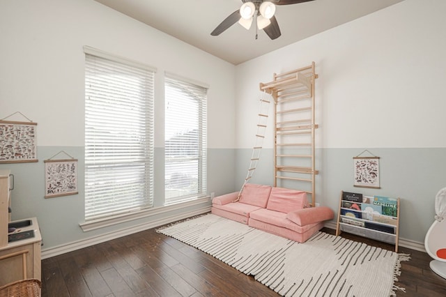 sitting room with hardwood / wood-style flooring, baseboards, and a ceiling fan