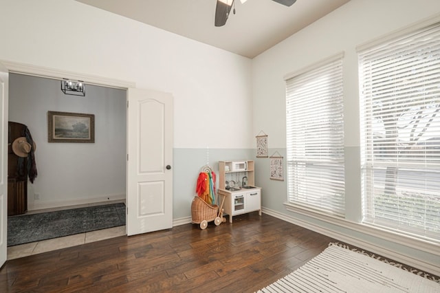 bedroom with baseboards, hardwood / wood-style flooring, and a ceiling fan