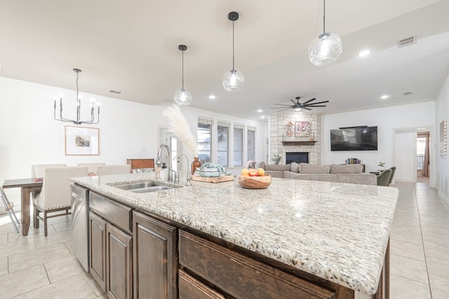 kitchen featuring a sink, visible vents, a ceiling fan, dishwasher, and a center island with sink