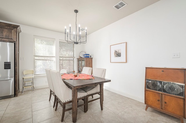 dining space featuring a chandelier, light tile patterned floors, visible vents, and baseboards