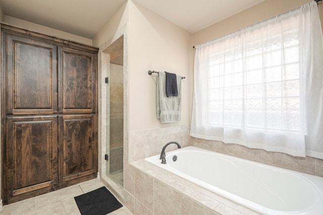 full bath with a bath, a stall shower, a wealth of natural light, and tile patterned floors