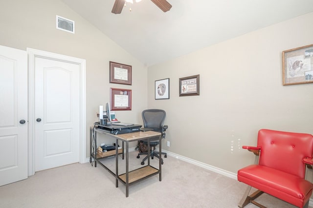 home office with visible vents, a ceiling fan, light carpet, vaulted ceiling, and baseboards