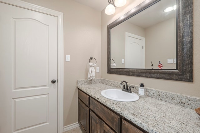 bathroom with vanity and baseboards