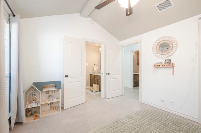 bedroom featuring vaulted ceiling with beams, visible vents, ensuite bathroom, a ceiling fan, and light carpet