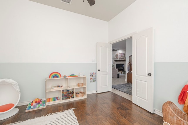 playroom with hardwood / wood-style flooring, baseboards, visible vents, and a ceiling fan