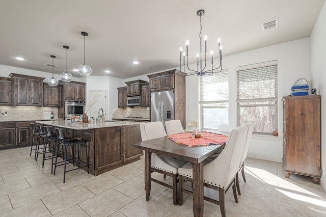 dining space with light tile patterned floors, baseboards, visible vents, an inviting chandelier, and recessed lighting