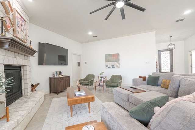 living room featuring ornamental molding, visible vents, and a fireplace