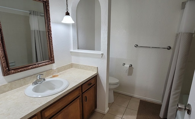 bathroom with tile patterned floors, vanity, toilet, and a shower with curtain