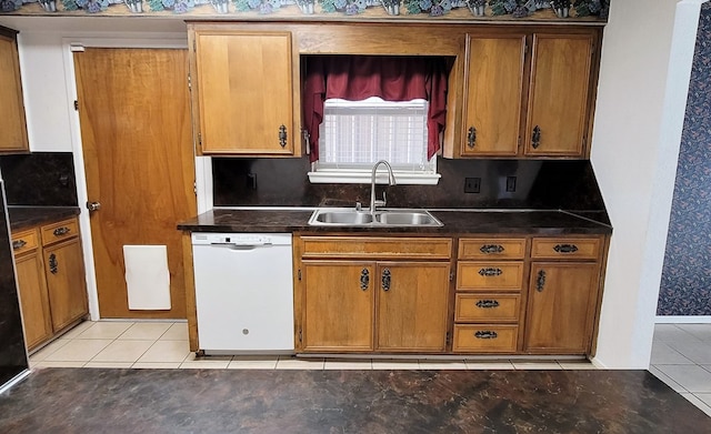 kitchen with white dishwasher, light tile patterned floors, and sink