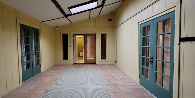 view of exterior entry featuring french doors and a patio