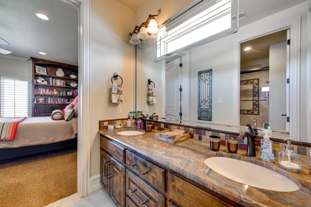 bathroom featuring tile patterned flooring and vanity