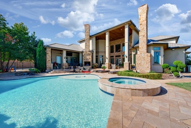 view of pool featuring an in ground hot tub and a patio